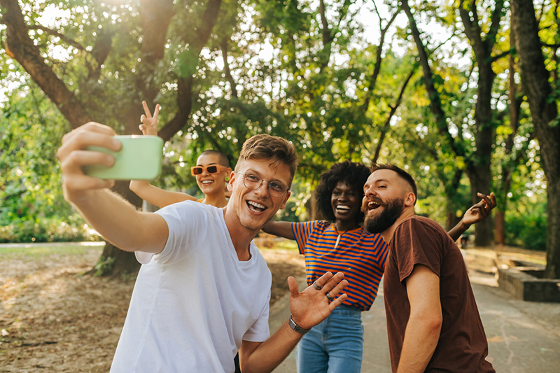 Group of friends taking a selfie in a park