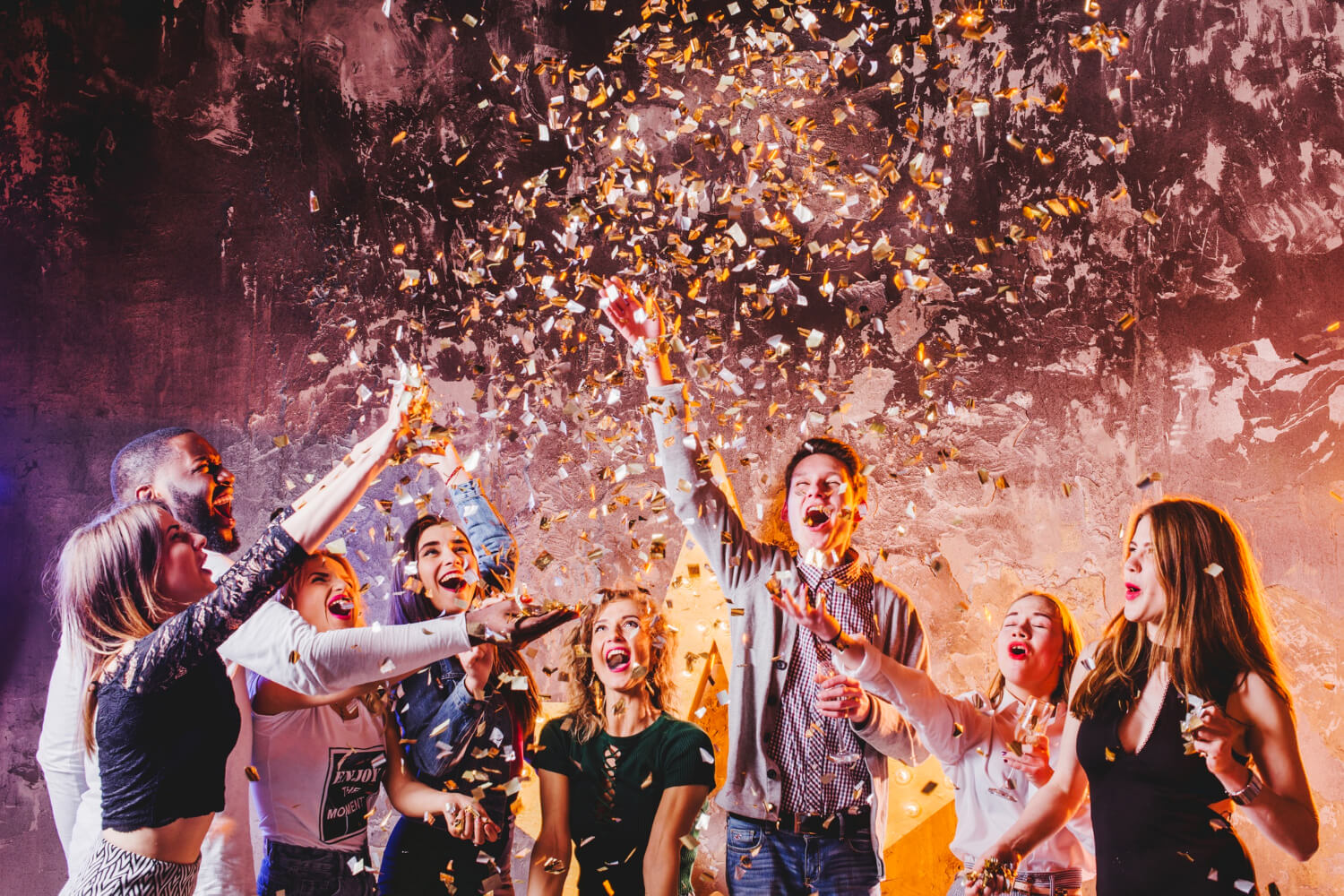 Friends celebrating with confetti at a party