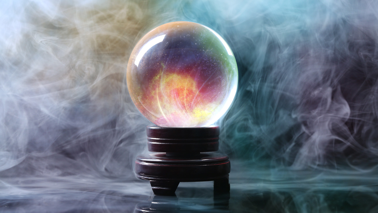 Crystal ball of a fortune teller in smoke on a table