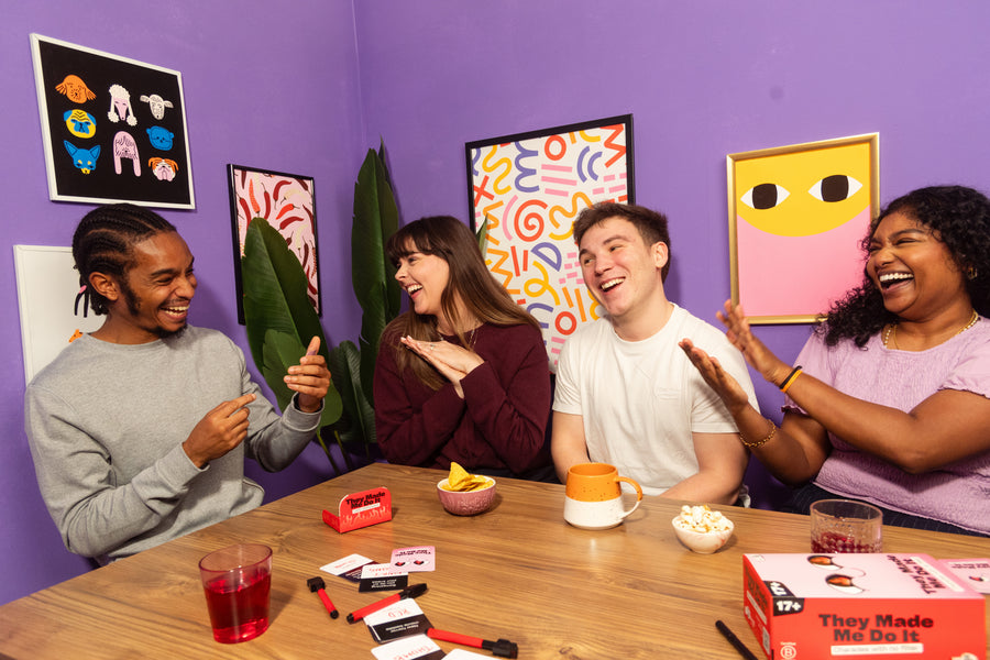 Friends laughing together at a party game night